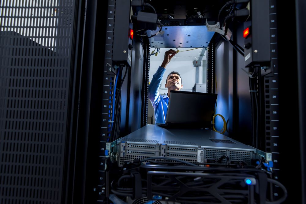 Man installing a network cabinet